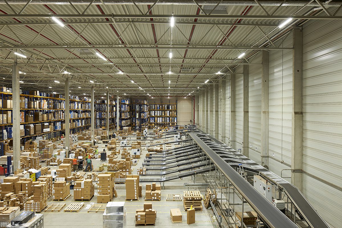A warehouse with good and machinery on the ground