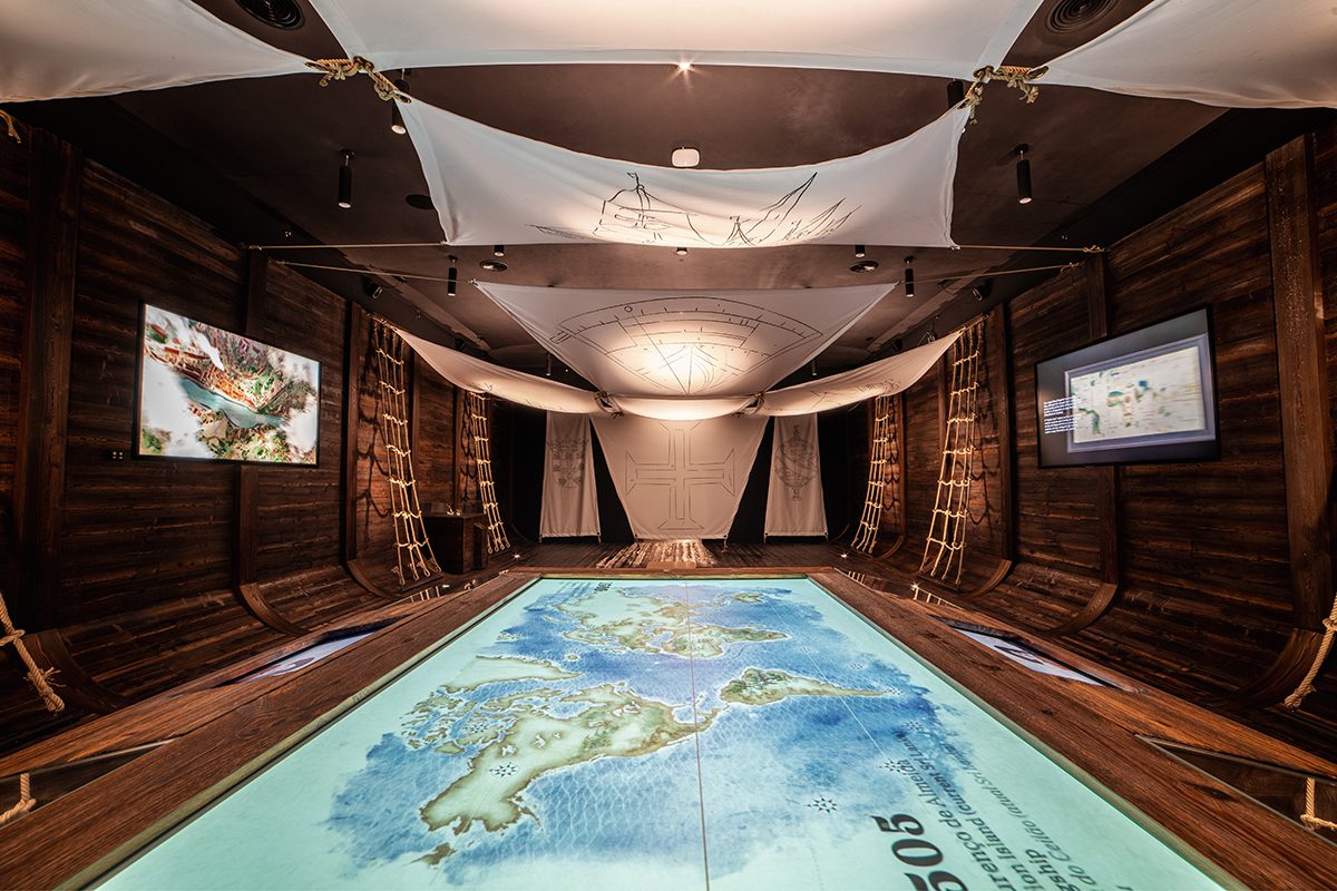 a blue map on the floor in a room that looks like a boat