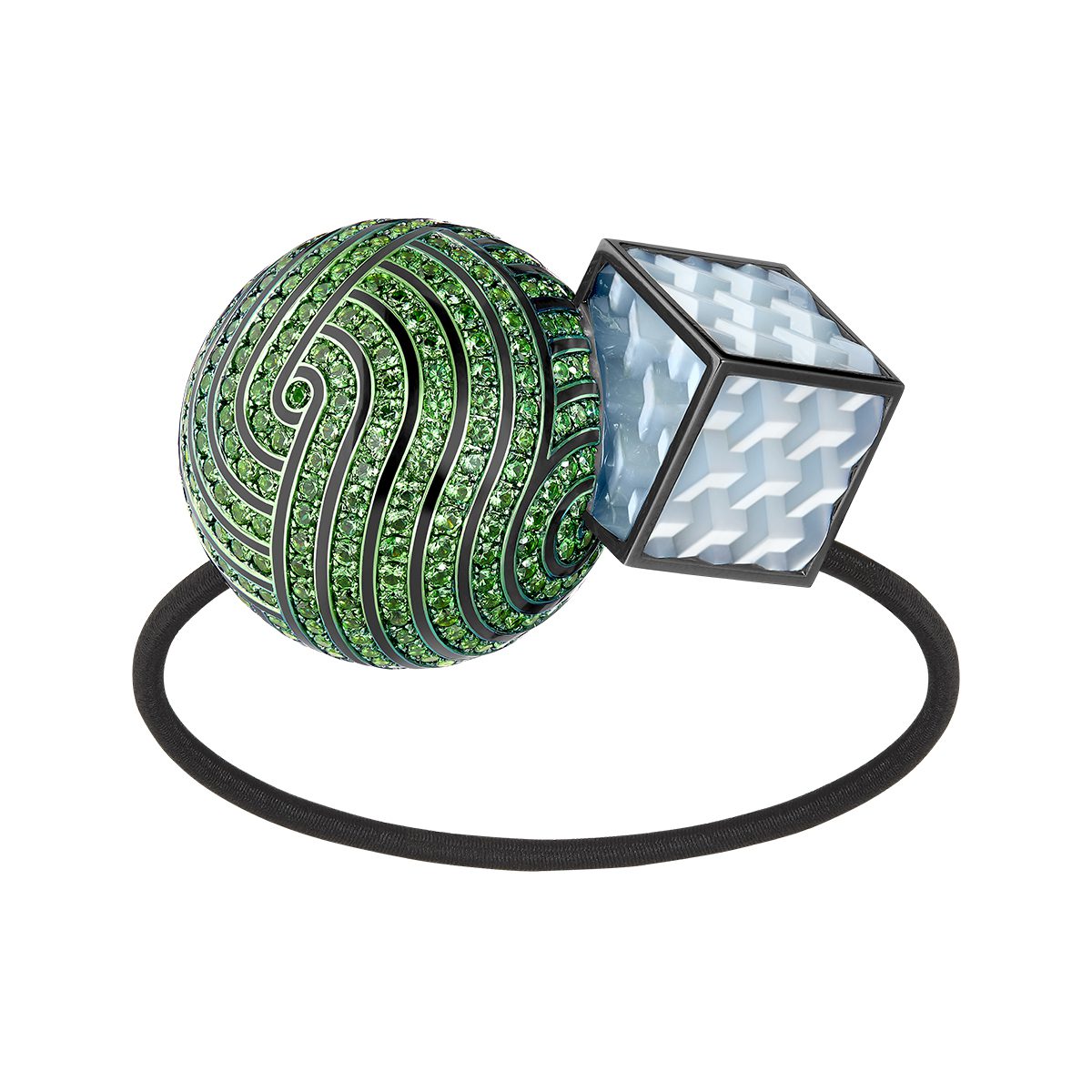 A hair tie with a green ball and blue cube on it