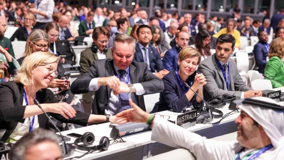 people shaking hands at a conference