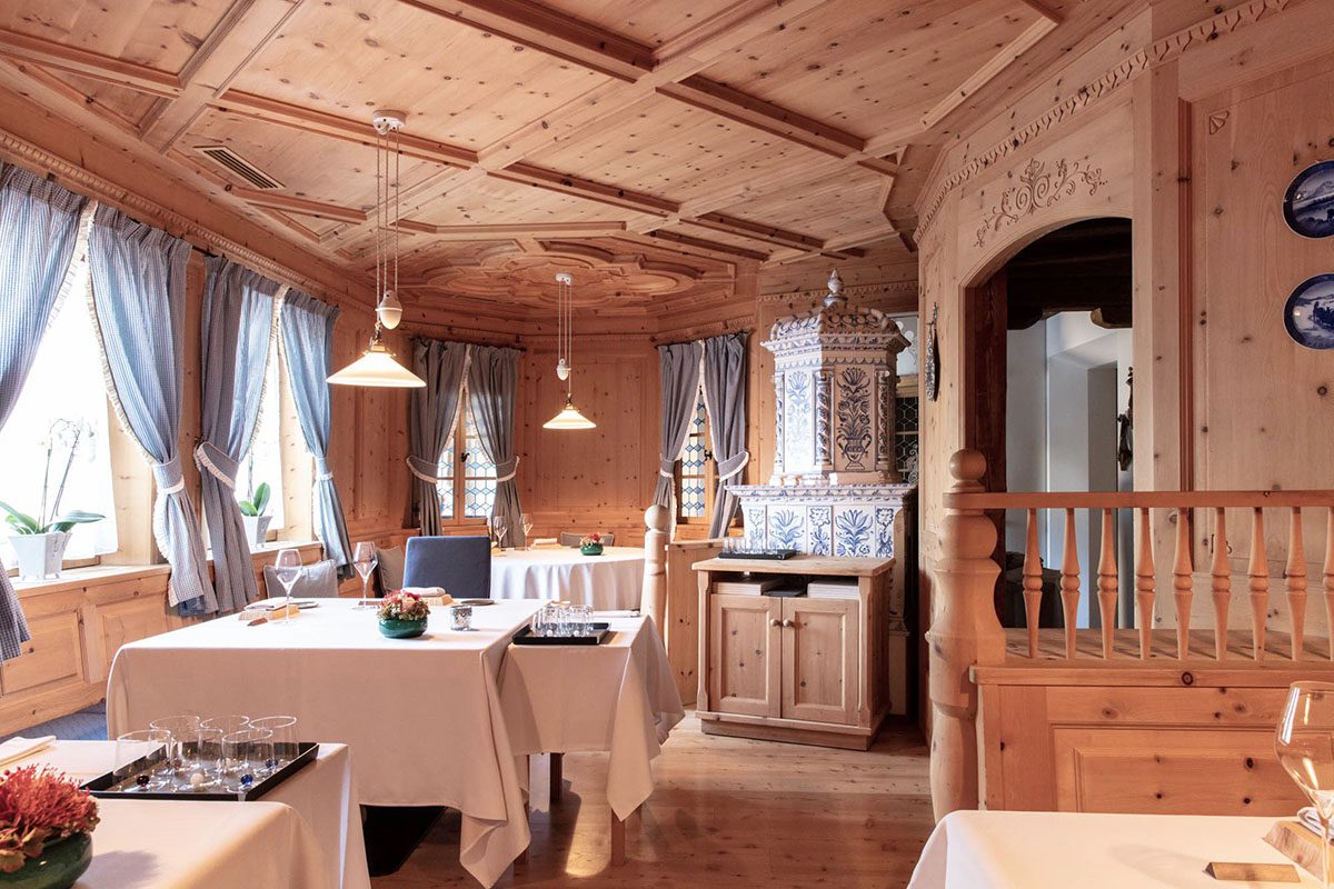 A wooden restaurant with white tablecloths 