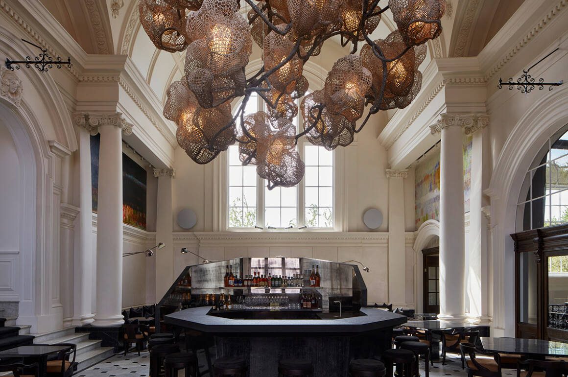 a room with big window and lights and bar