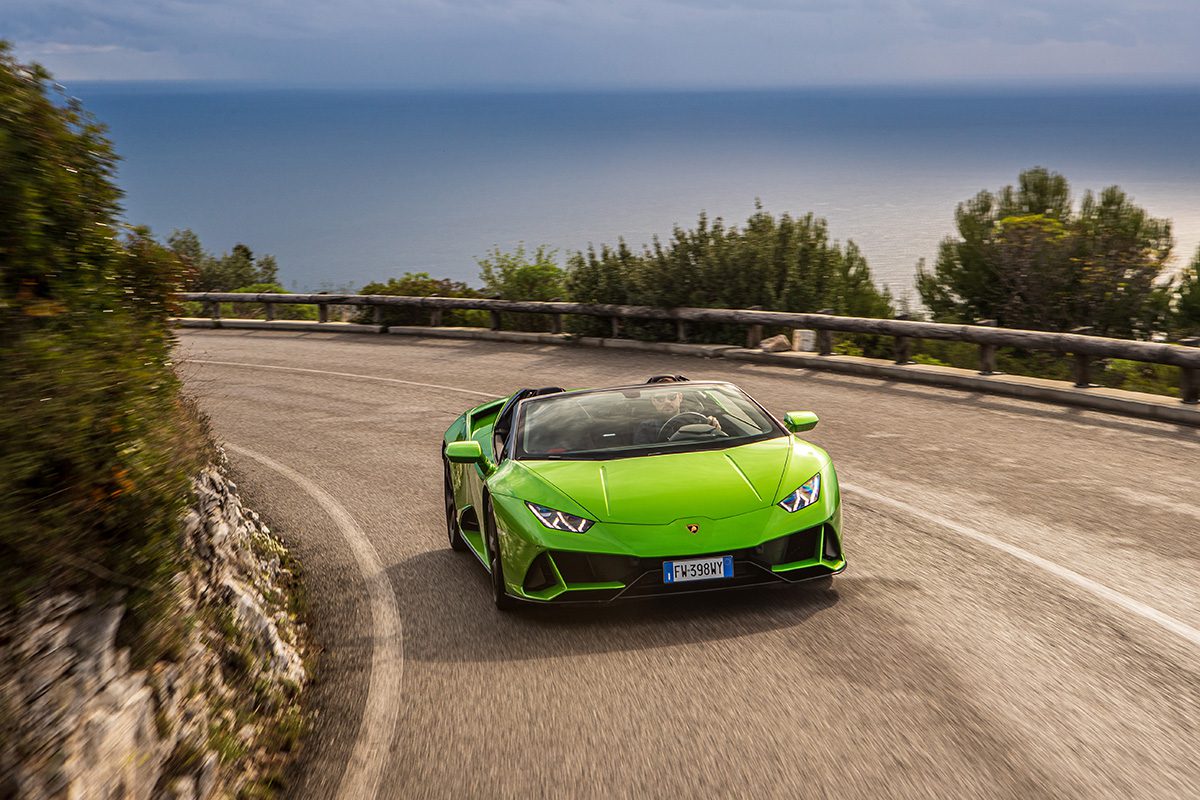Green sports car on empty road