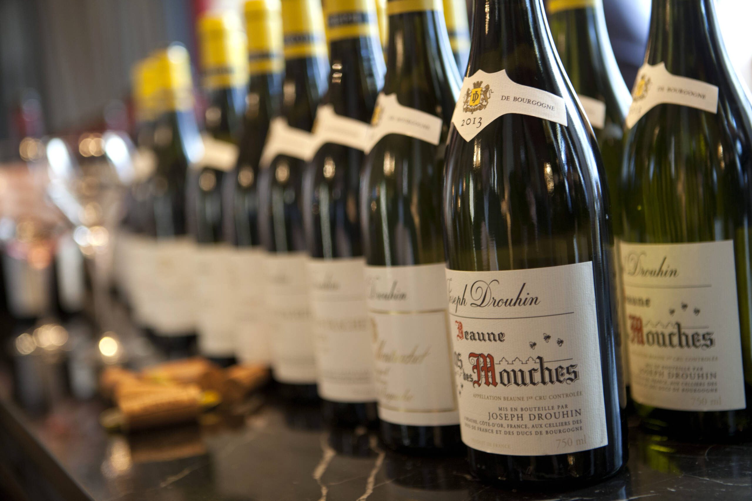 Multiple wine bottles standing next to each other