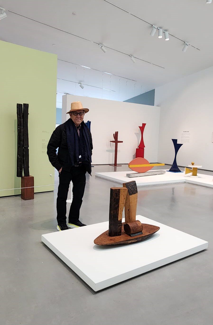 Man standing next to a sculpture