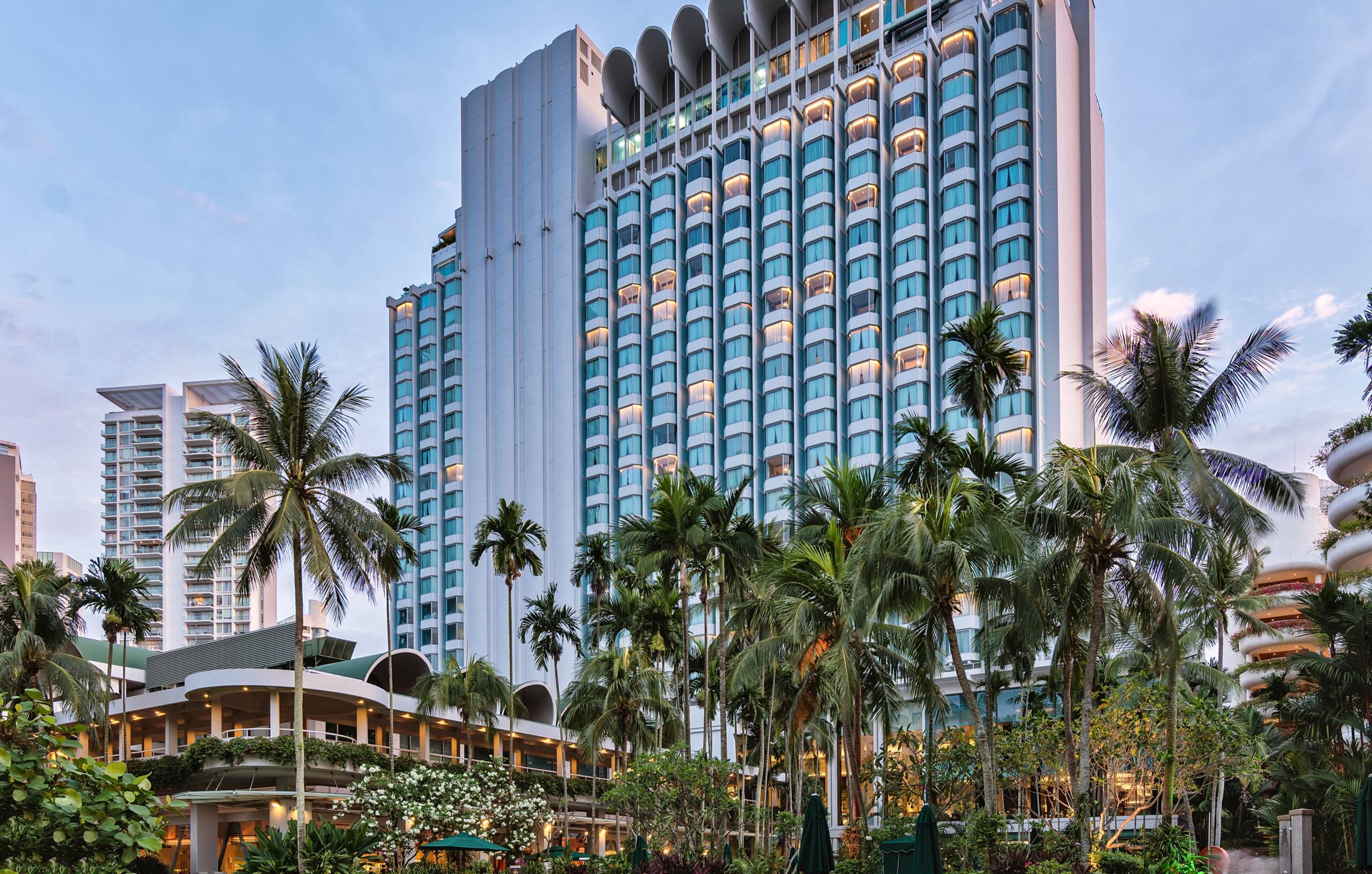 big hotel building with lots of green