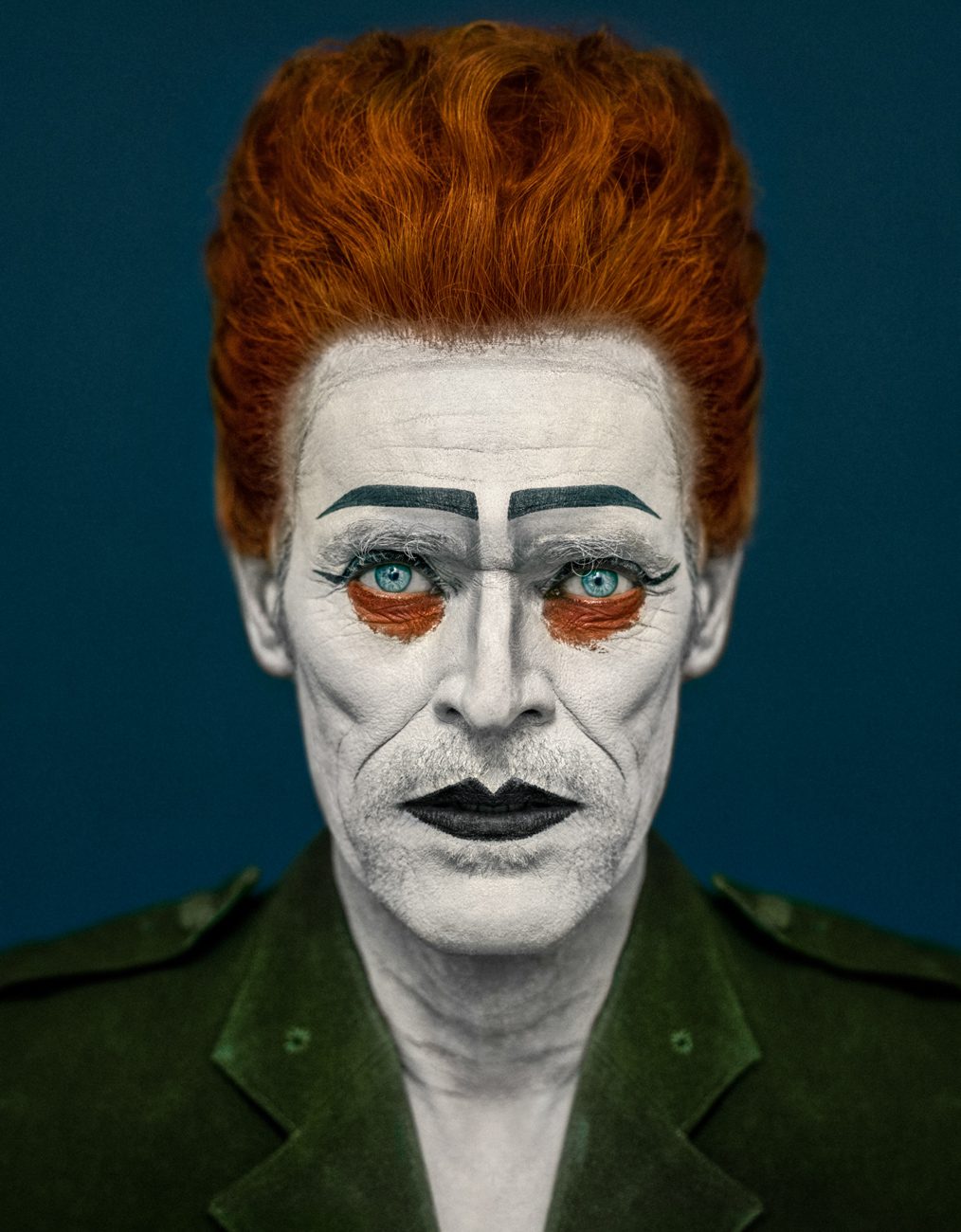 man with red hair and blue background