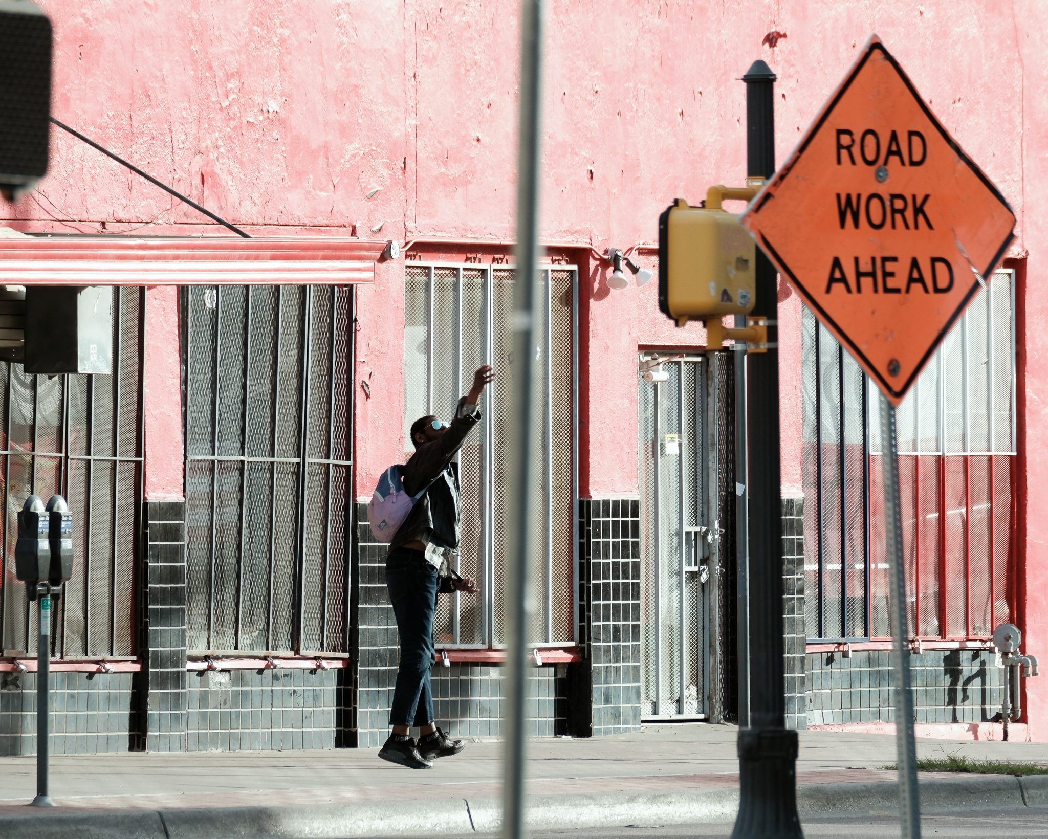 a man reaching with a sign