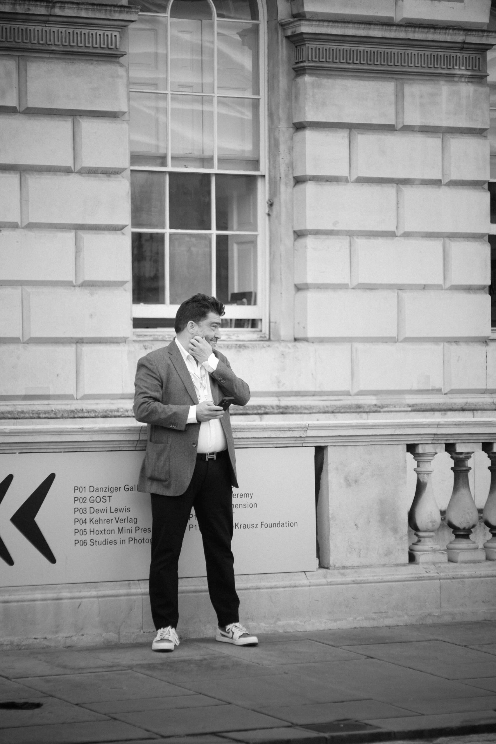man standing outside a building in a suit