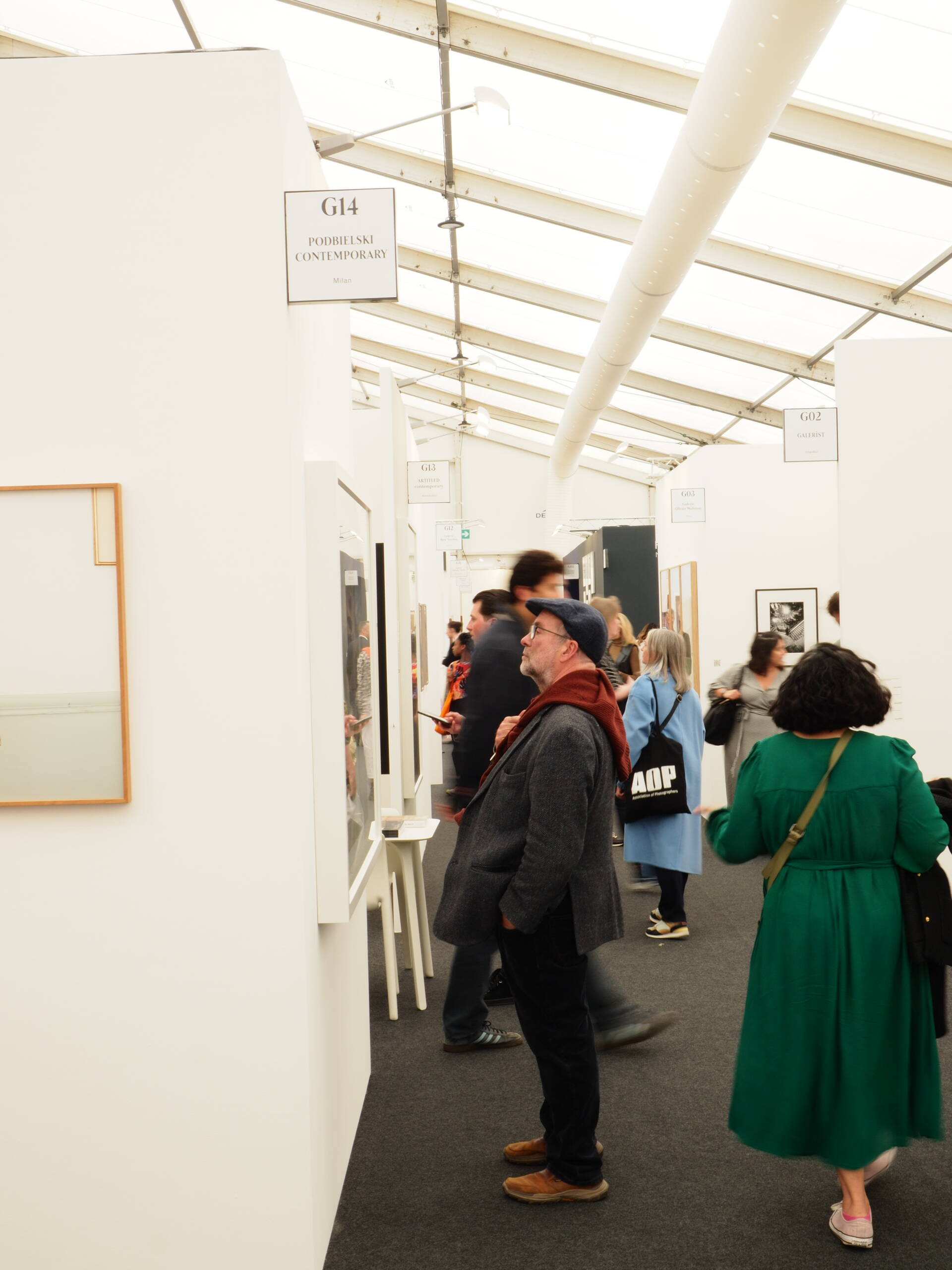 man looking at picture in an art fair