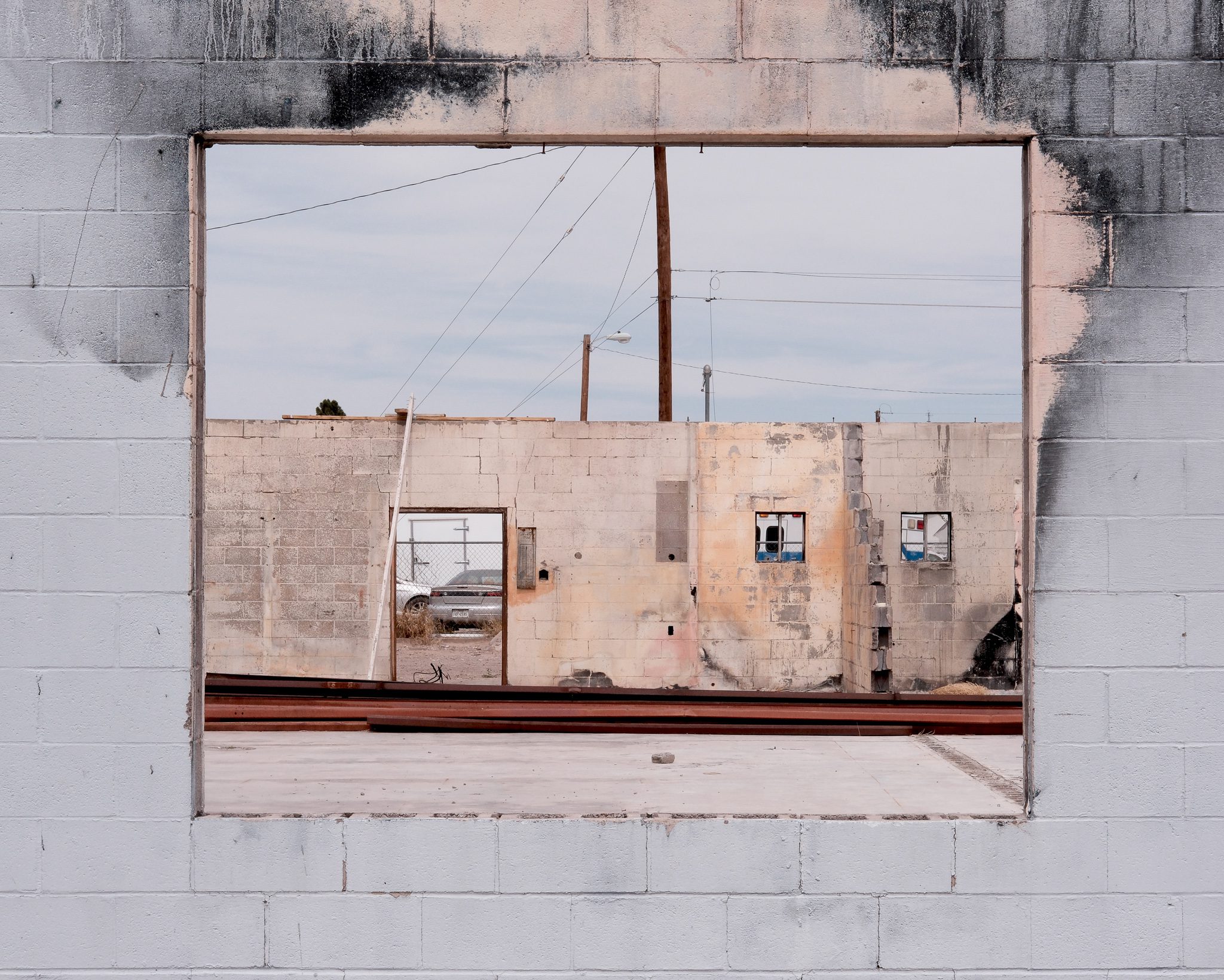 Buildings looking through a wall with pinkish and blue colours