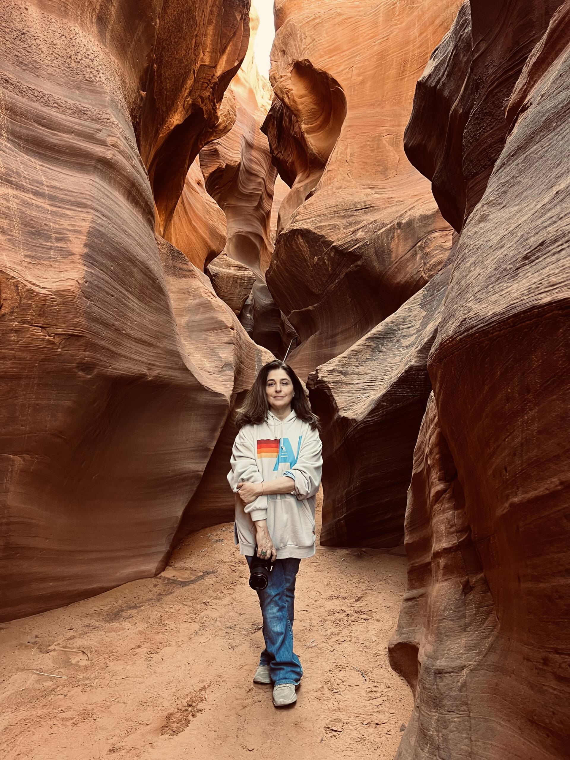 A woman with a camera in the canyons