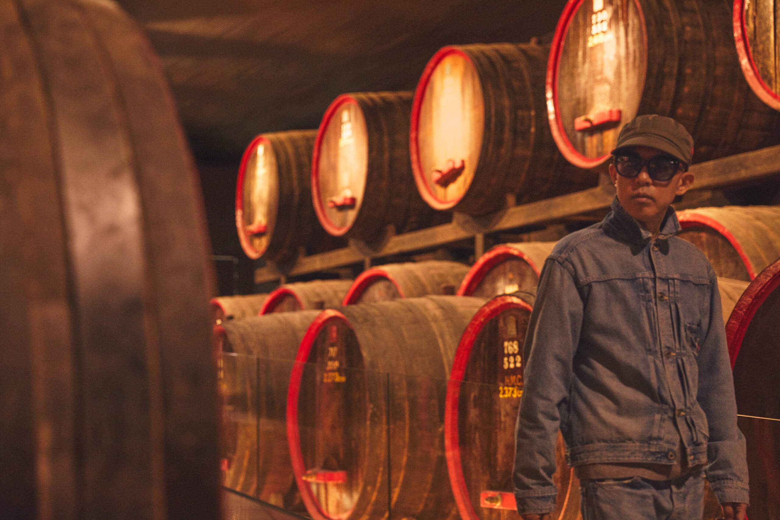 a man with lots of wine barrels