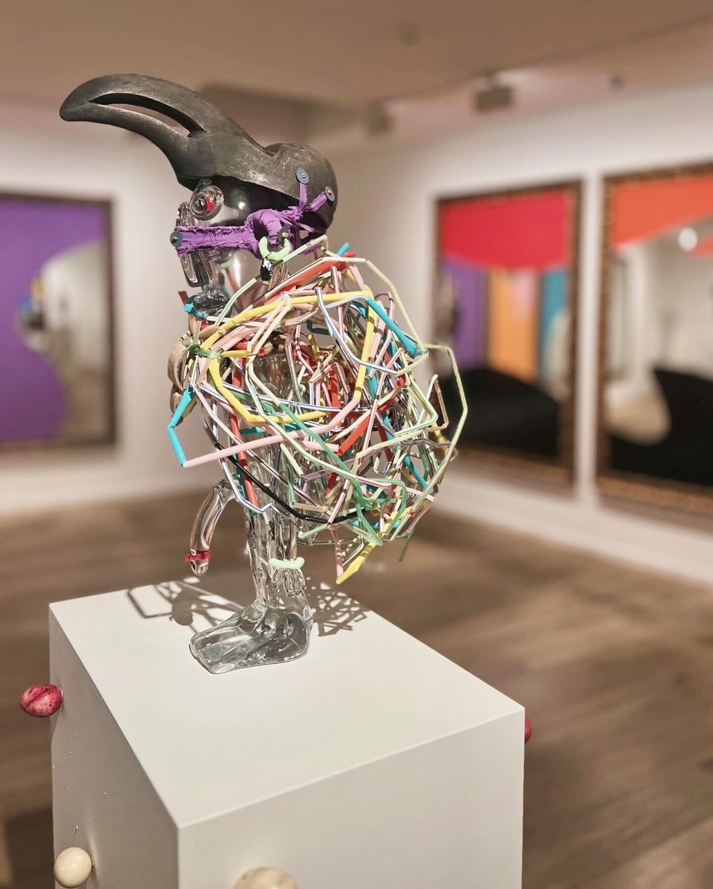 A sculpture with picture behind it.